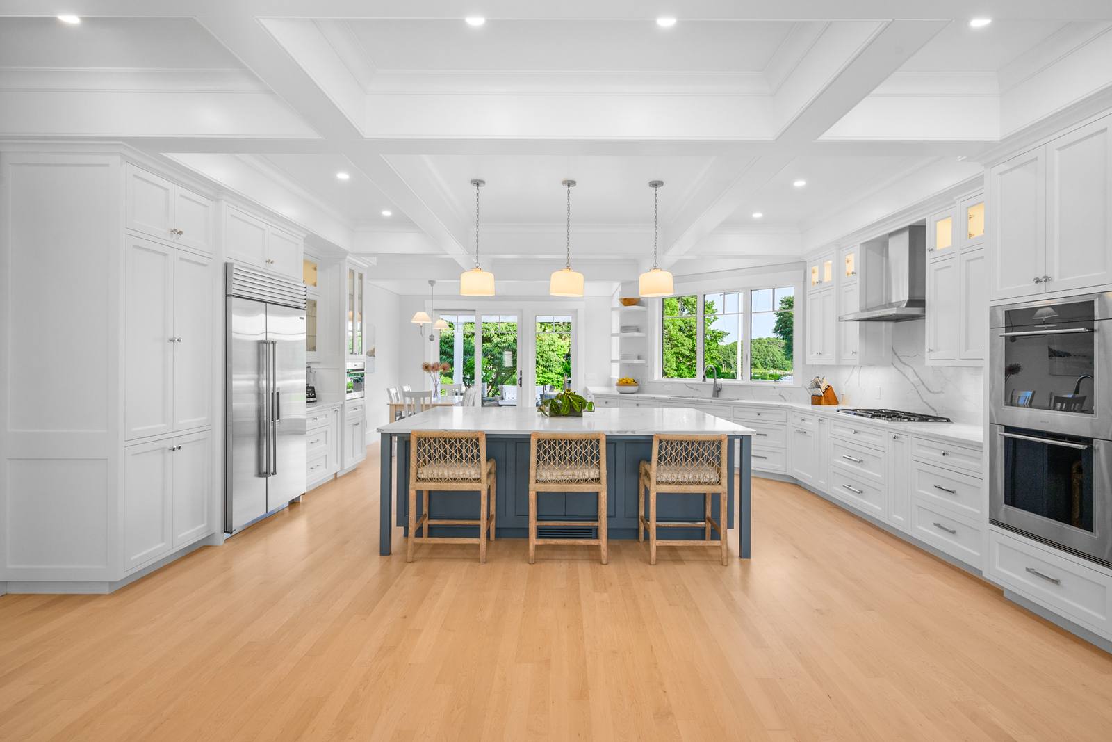 Chef's kitchen with coffered ceiling and oversized island